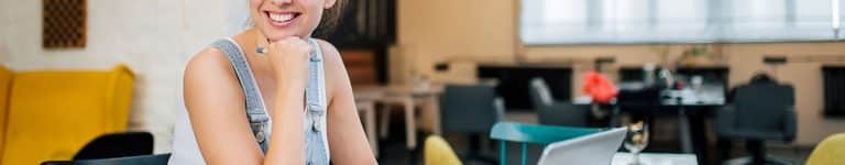 Smiling woman at laptop on desk